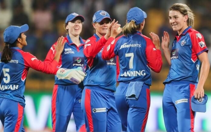 Delhi Capitals Women celebrate after taking wickets.